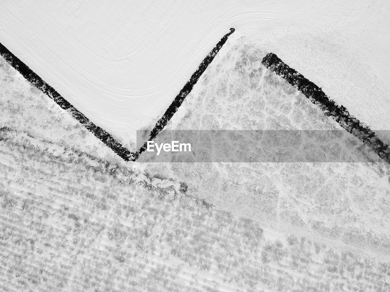 HIGH ANGLE VIEW OF ICE ON LAND