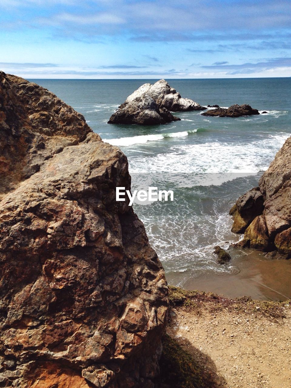 SCENIC VIEW OF SEA WITH ROCKS IN BACKGROUND