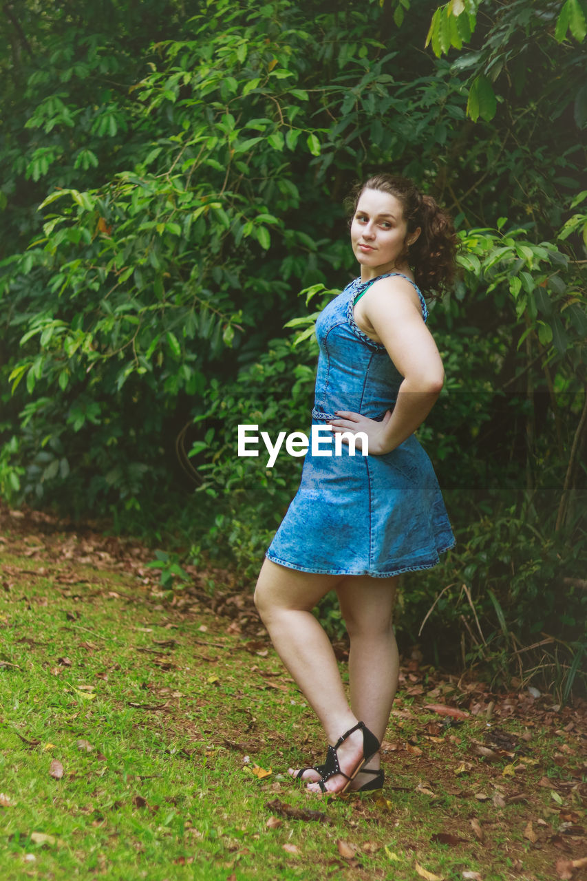 Beautiful young woman standing in park