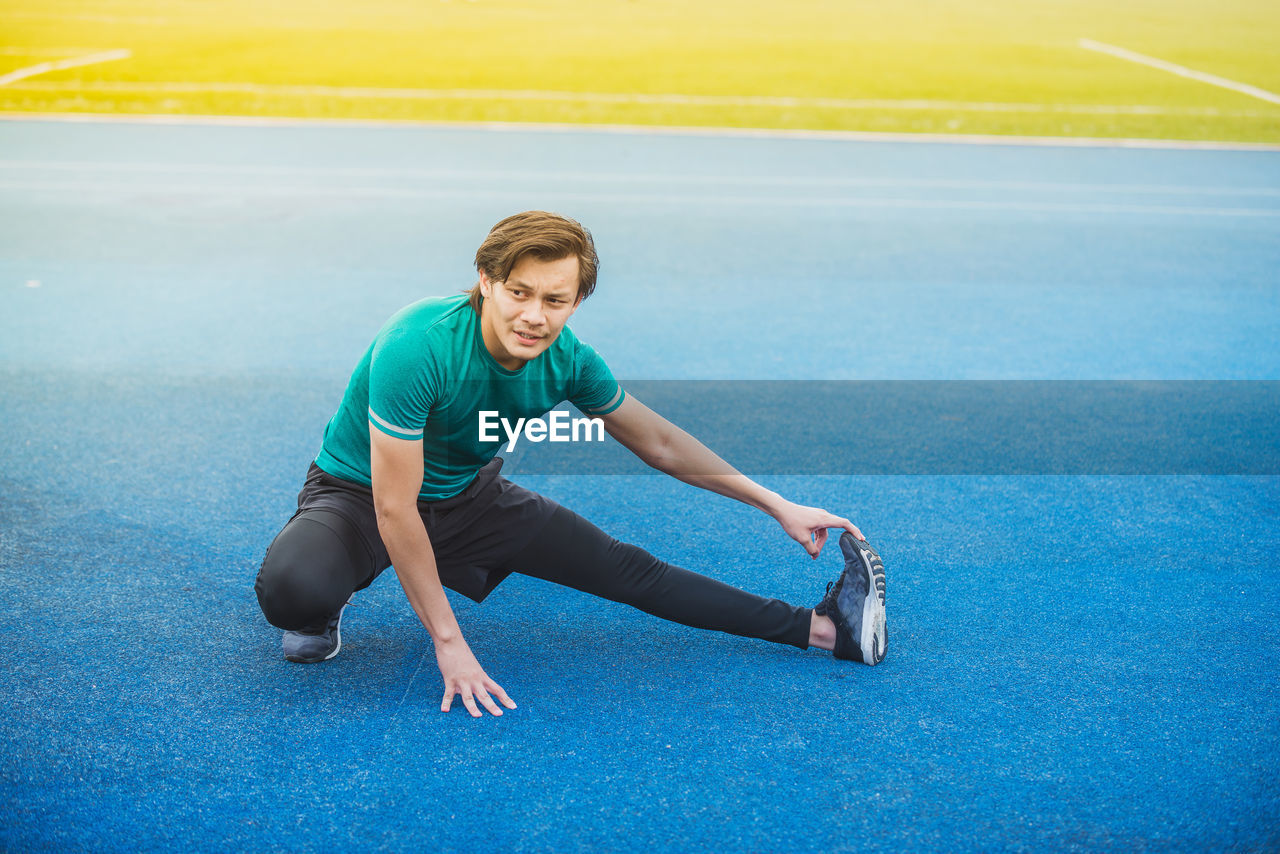 Young man exercising at stadium