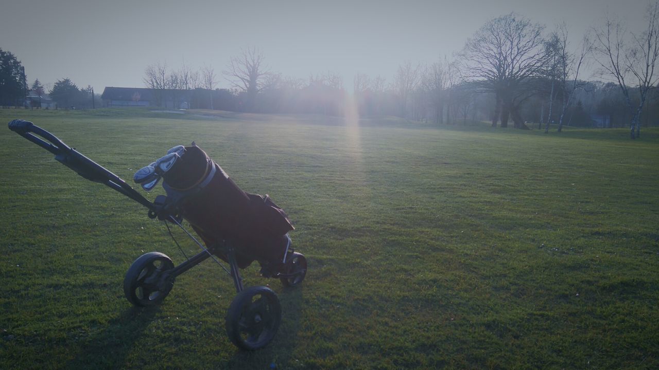 BICYCLE ON GOLF COURSE AGAINST SKY