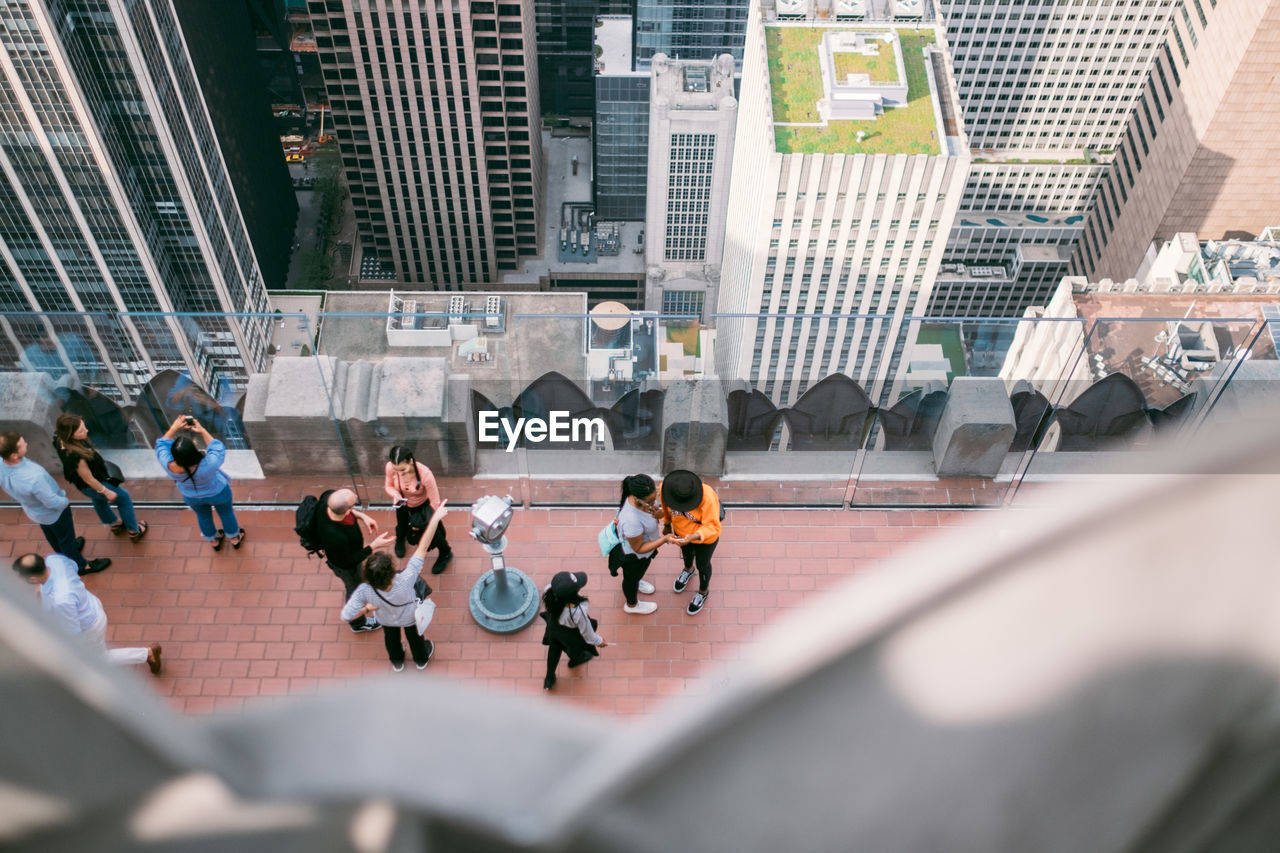 HIGH ANGLE VIEW OF PEOPLE WALKING ON BUILDING