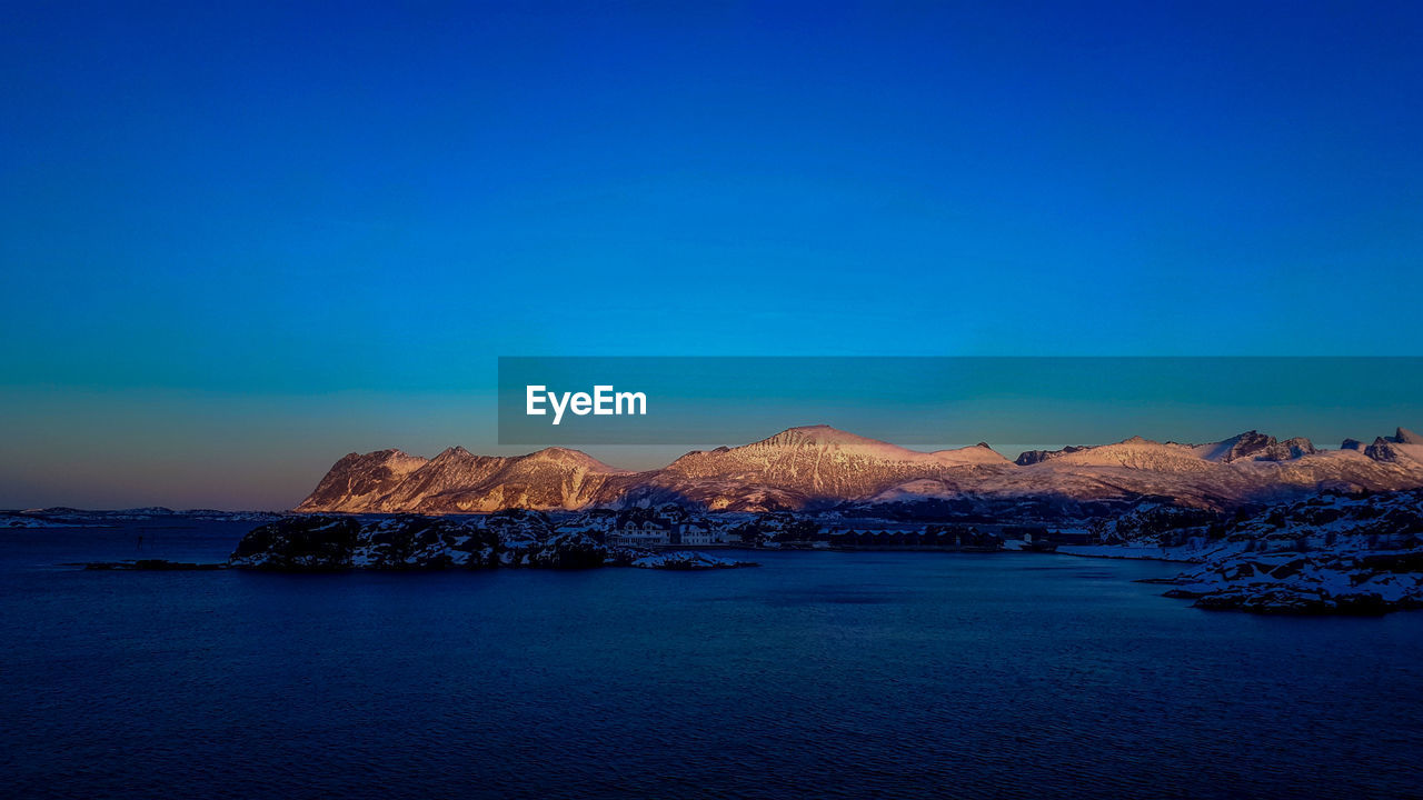 Scenic view of sea against clear blue sky