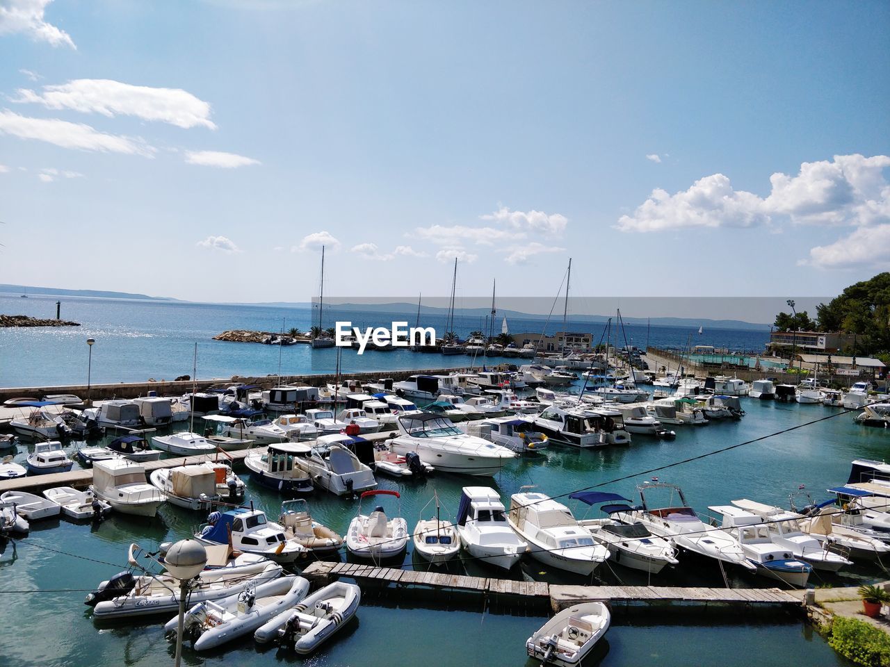 HIGH ANGLE VIEW OF SAILBOATS MOORED IN HARBOR