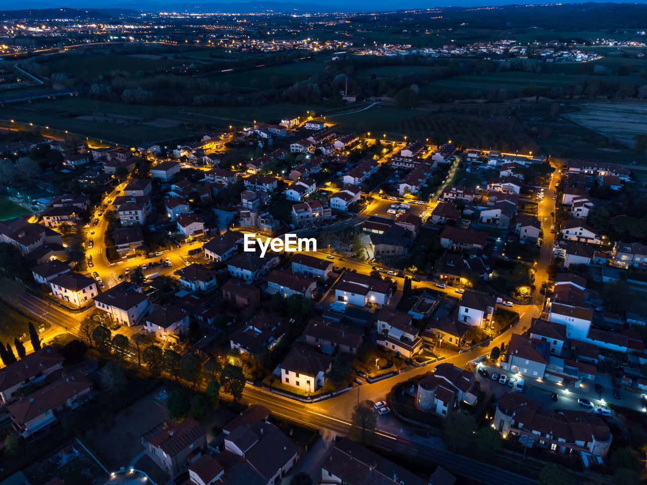 High angle view of illuminated city buildings at night