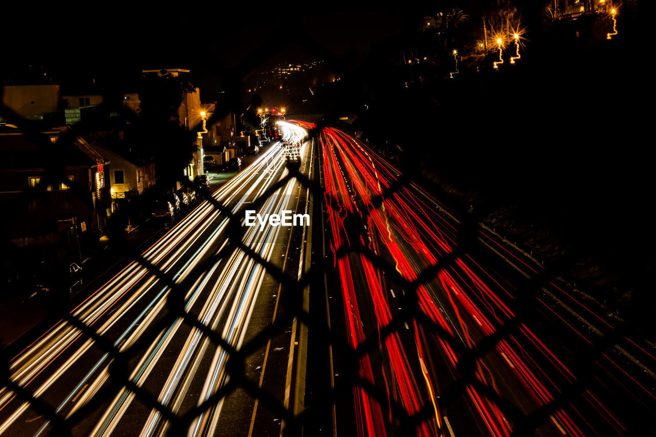 HIGH ANGLE VIEW OF LIGHT TRAILS IN CITY AT NIGHT