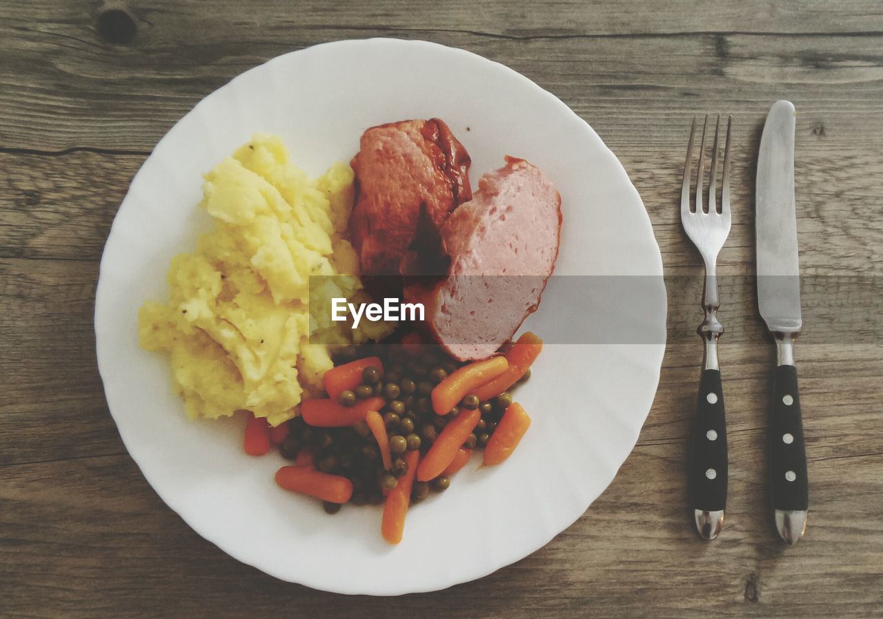 High angle view of meat with scrambled eggs served in plate on table