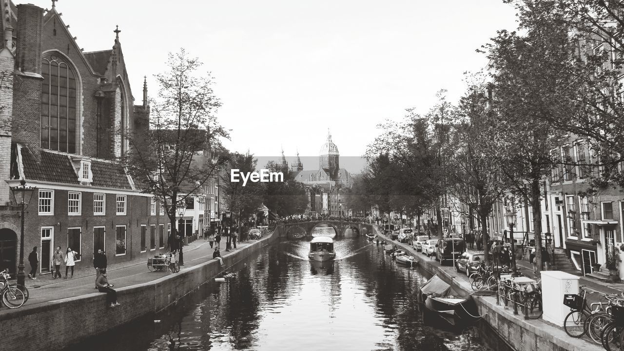 CANAL PASSING THROUGH CITY AGAINST SKY