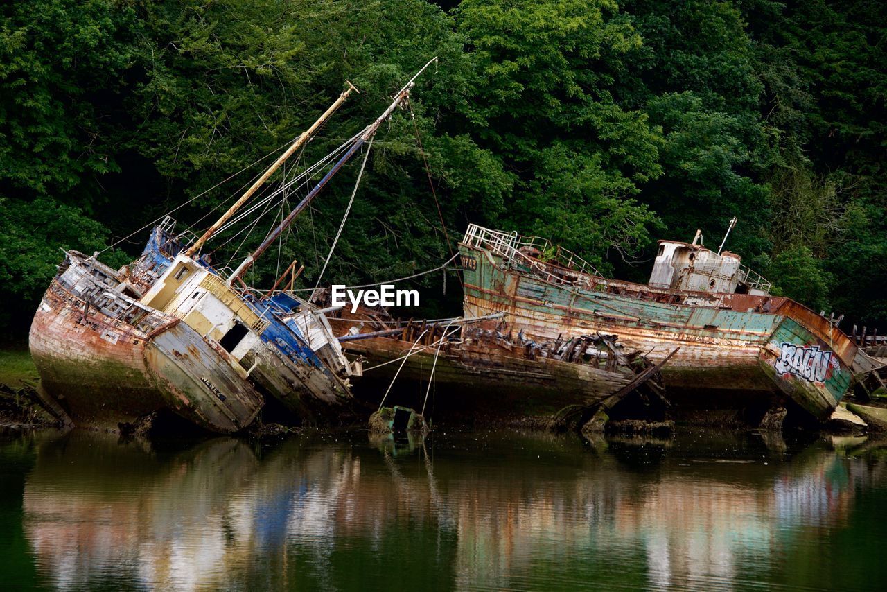 Abandoned boats at lakeside