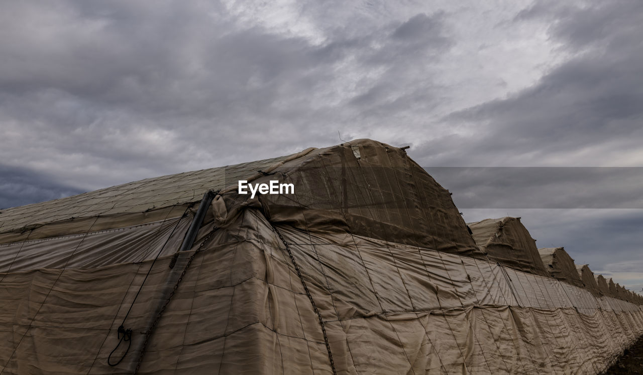 cloud, sky, nature, rock, architecture, monument, environment, no people, travel destinations, outdoors, travel, sand, history, landscape, land, built structure, mountain, day, the past, low angle view