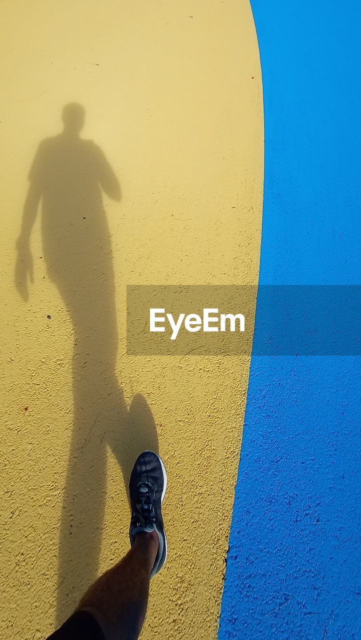 Low section of man walking on footpath