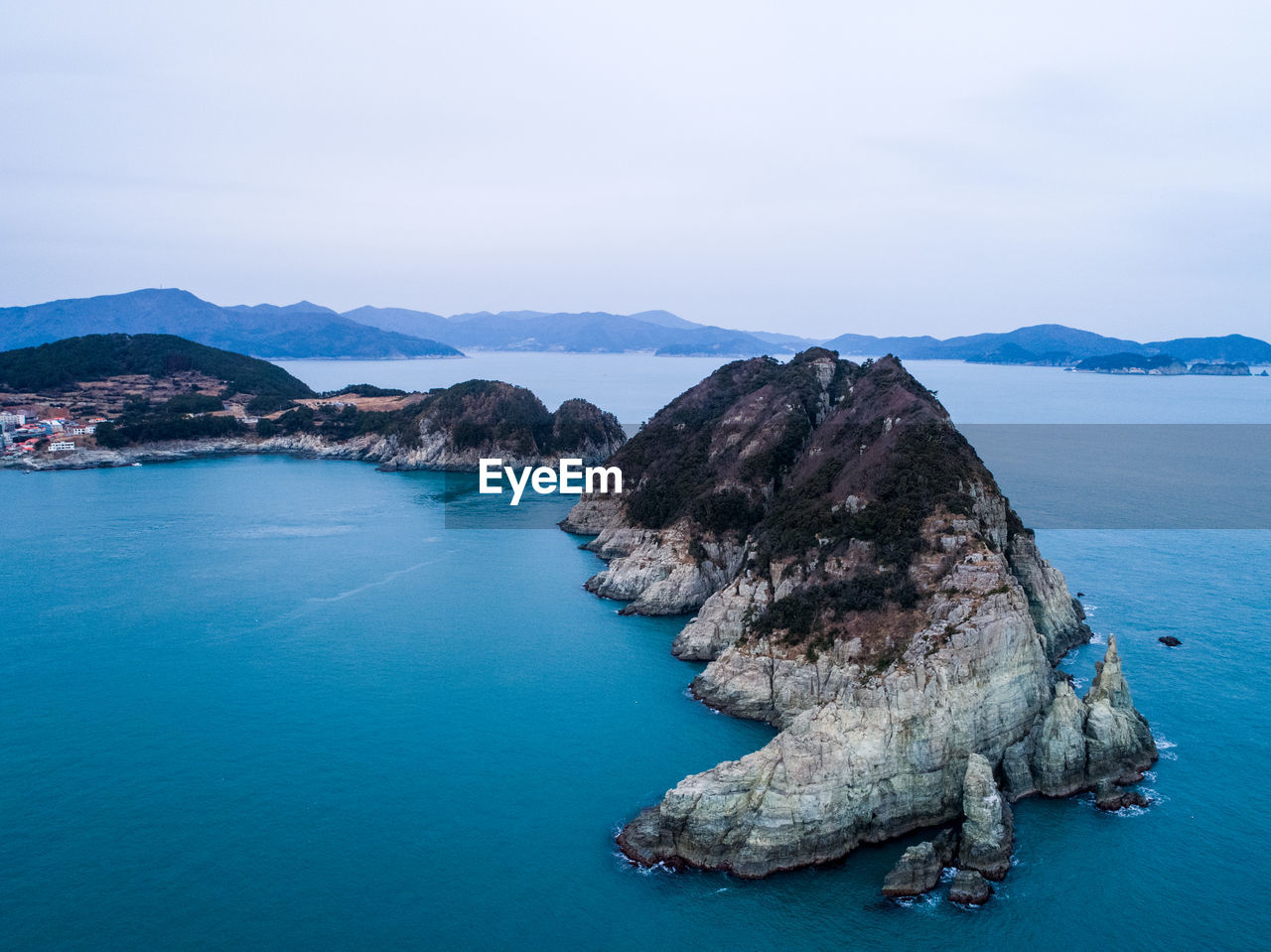 Panoramic view of sea and mountains against sky