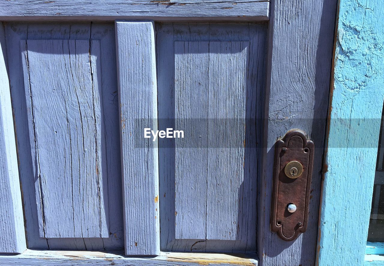 CLOSE-UP OF CLOSED DOOR AGAINST BLUE WALL