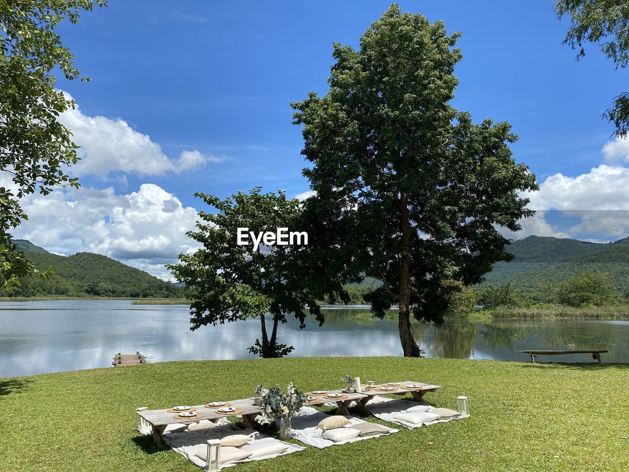 Scenic view of lake by trees against sky