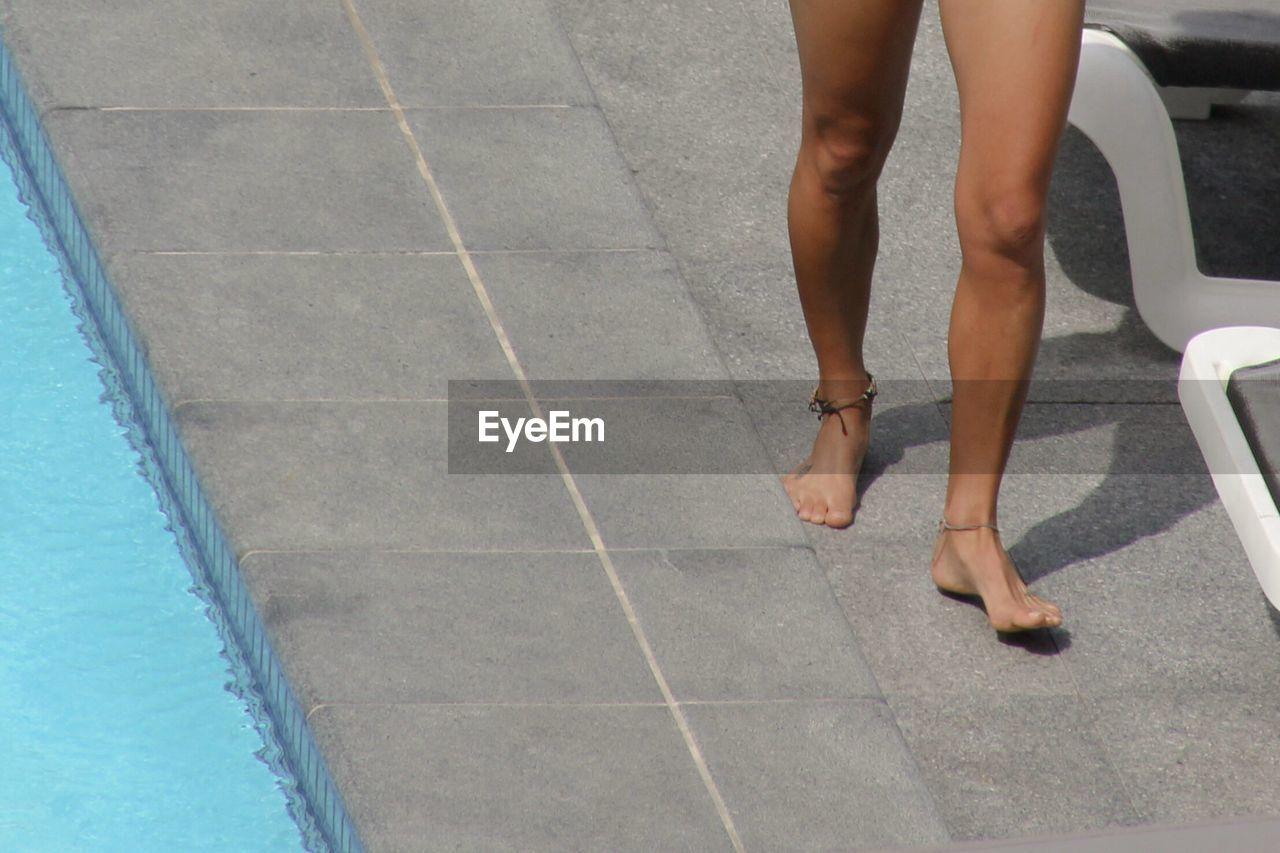 High angle view of woman walking close to swimming pool