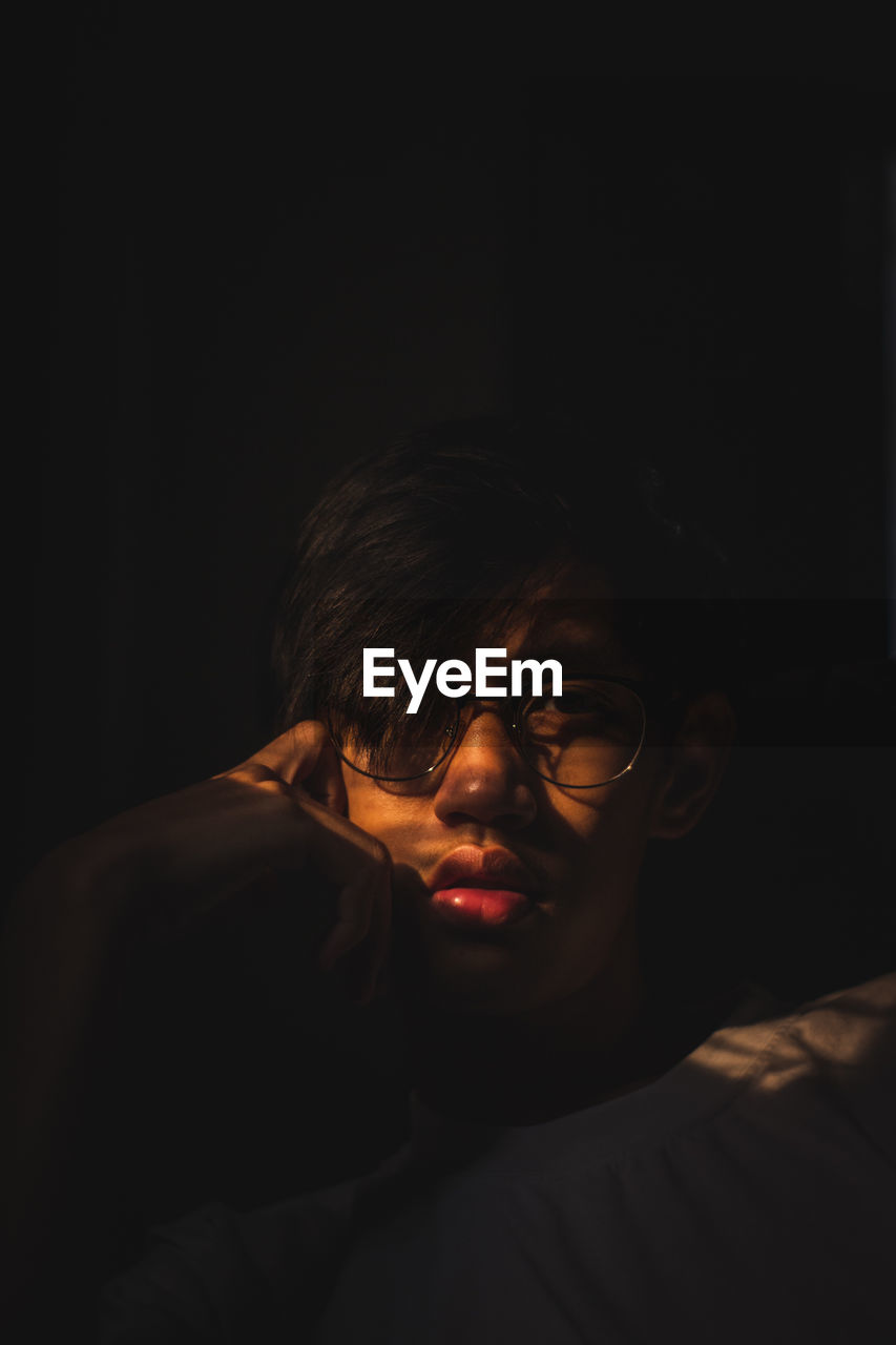 Portrait of young man in darkroom