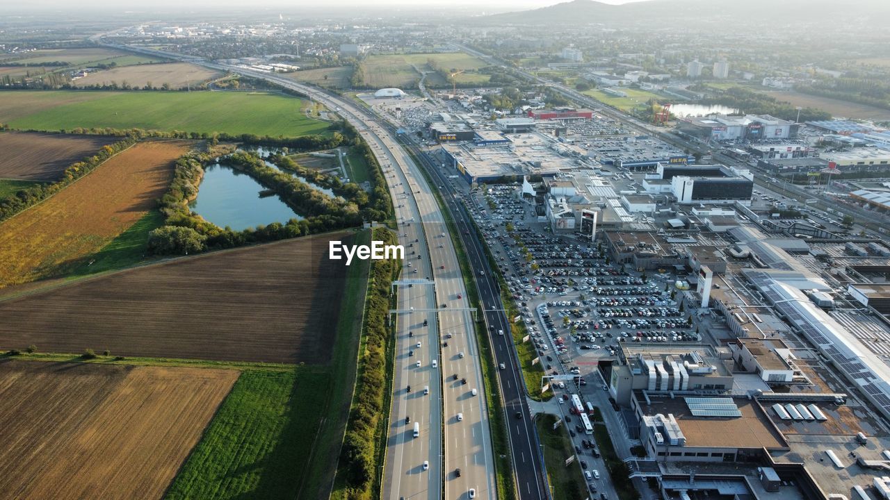 HIGH ANGLE VIEW OF ROAD AMIDST CITYSCAPE