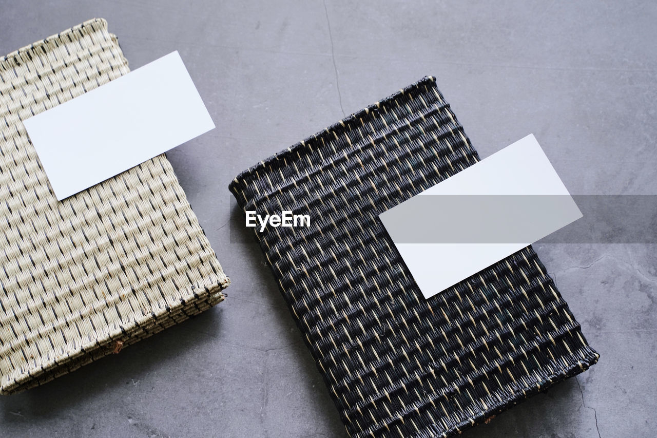 High angle view of blank papers over mats on table