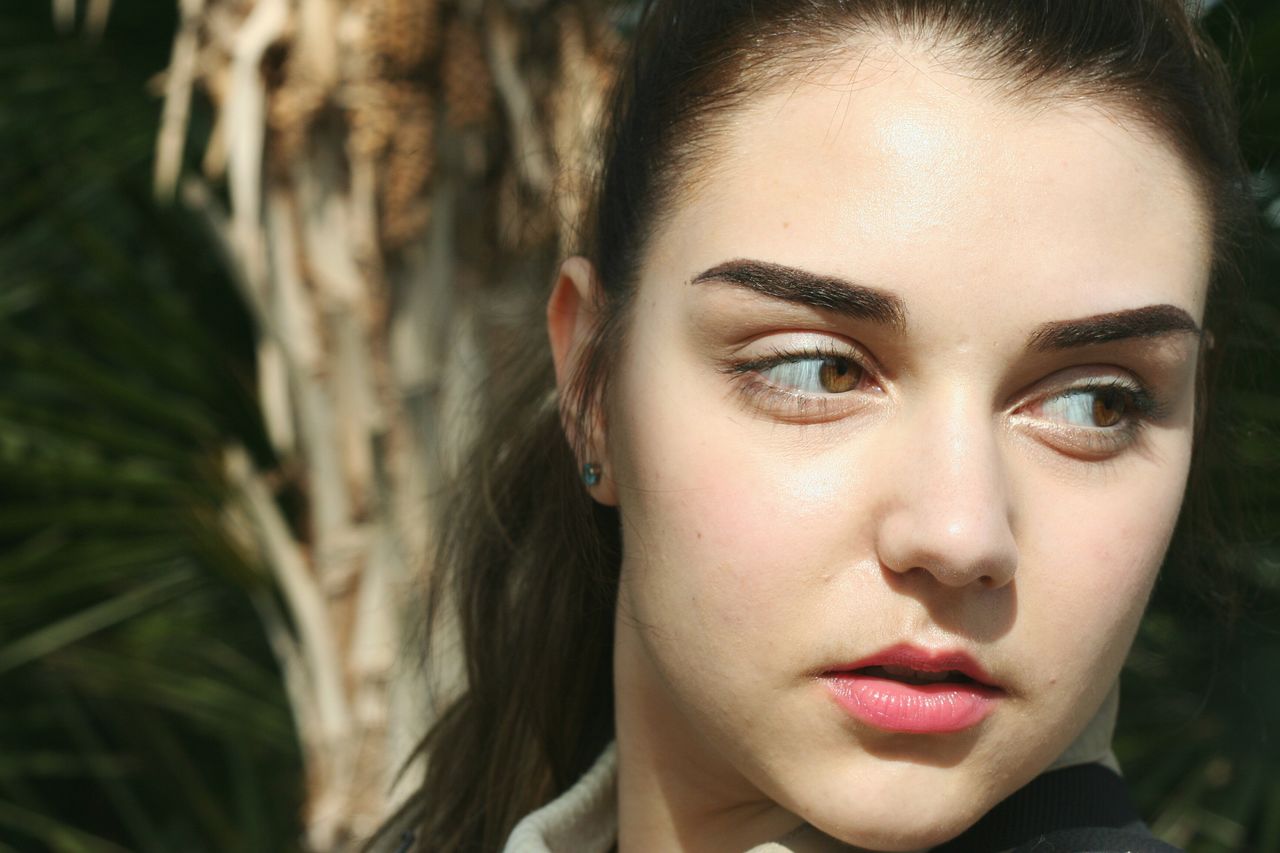 Close-up of young woman looking away