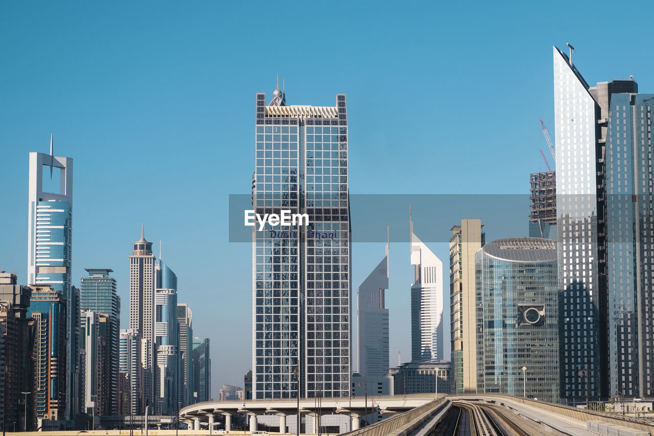 MODERN BUILDINGS AGAINST BLUE SKY