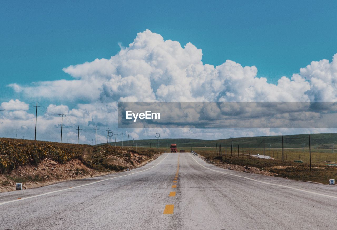 Road on field against sky