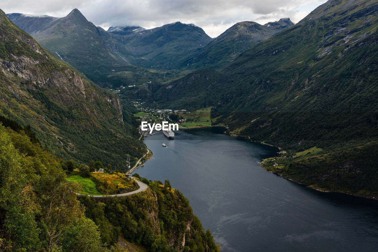 High angle view of river amidst mountains against sky