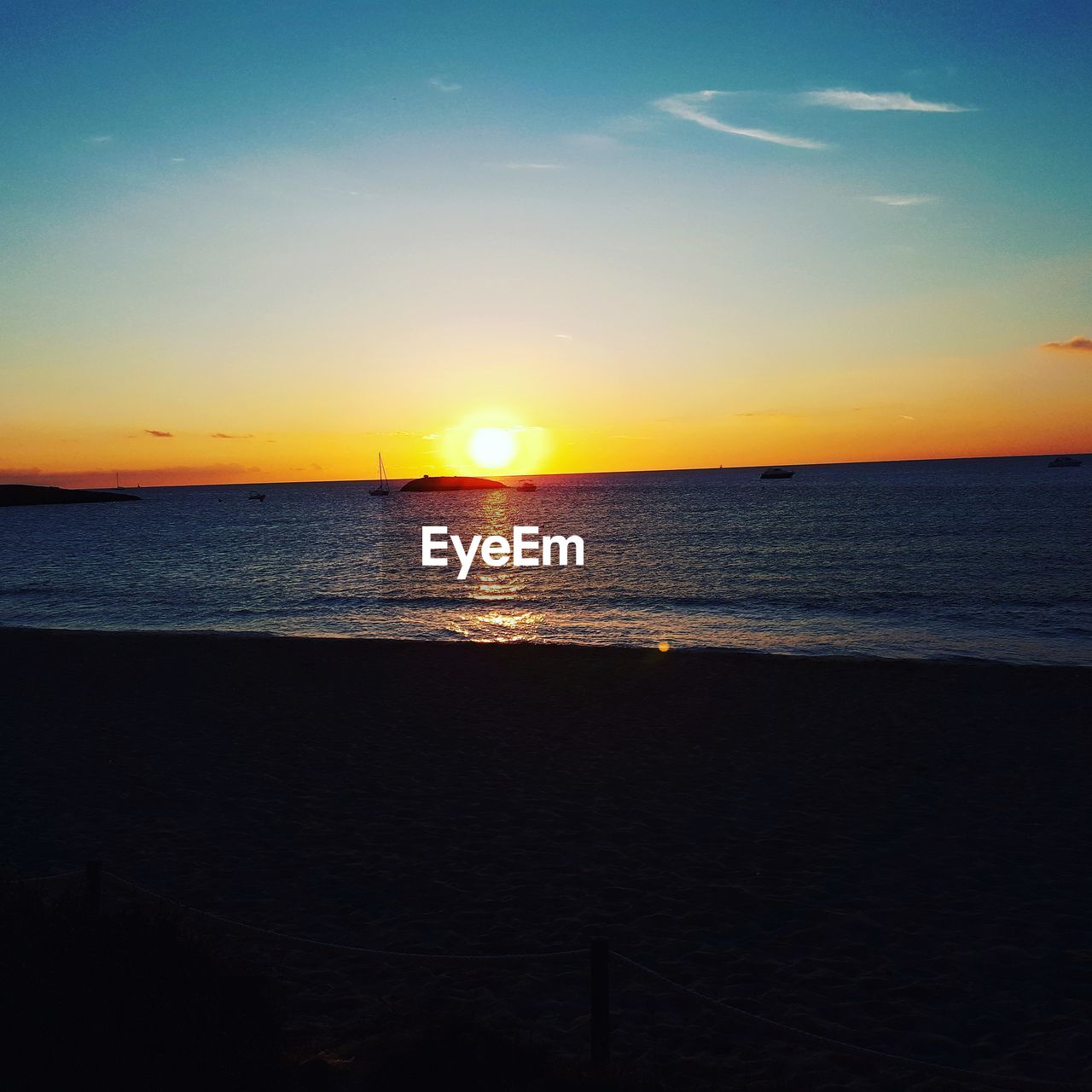 SCENIC VIEW OF BEACH DURING SUNSET