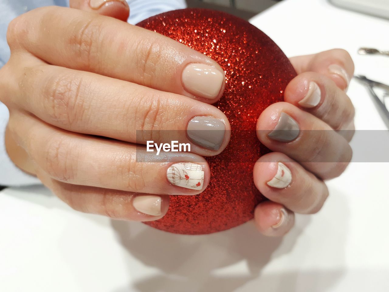 Cropped hands of woman holding red bauble