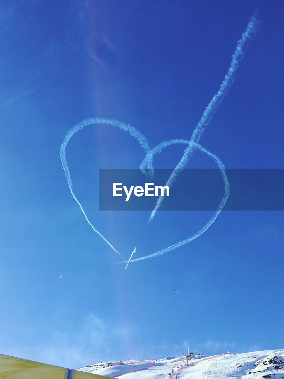 Heart shape of vapor trails in blue sky