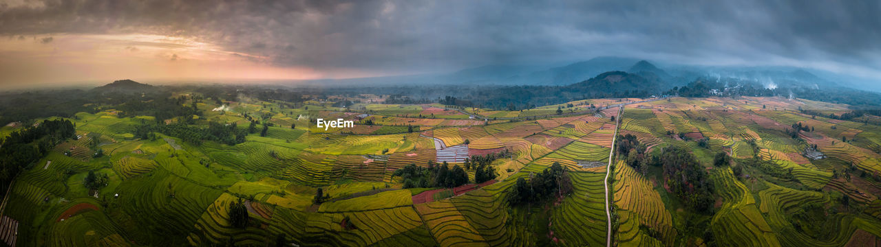 Panoramic view of agricultural landscape against sky