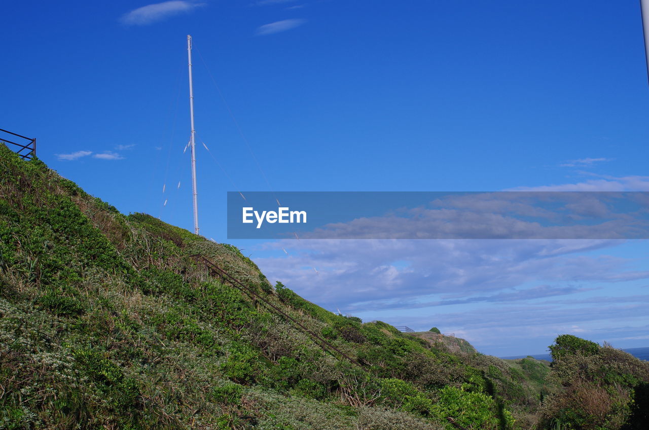 Scenic view of landscape against blue sky