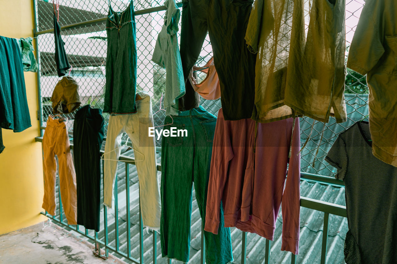 Rear view of clothes hanging at market stall