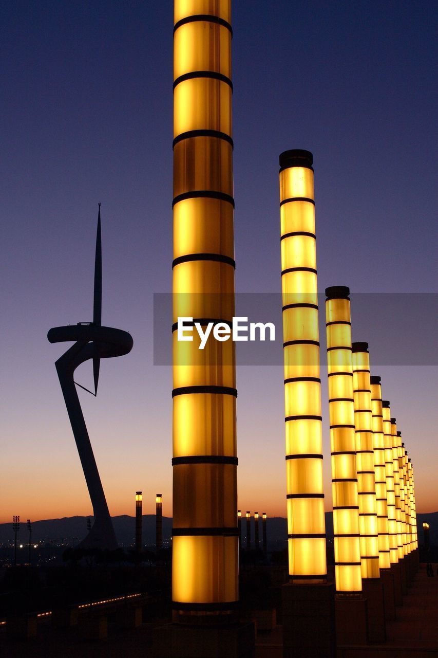 Communication tower and illuminated street lamps