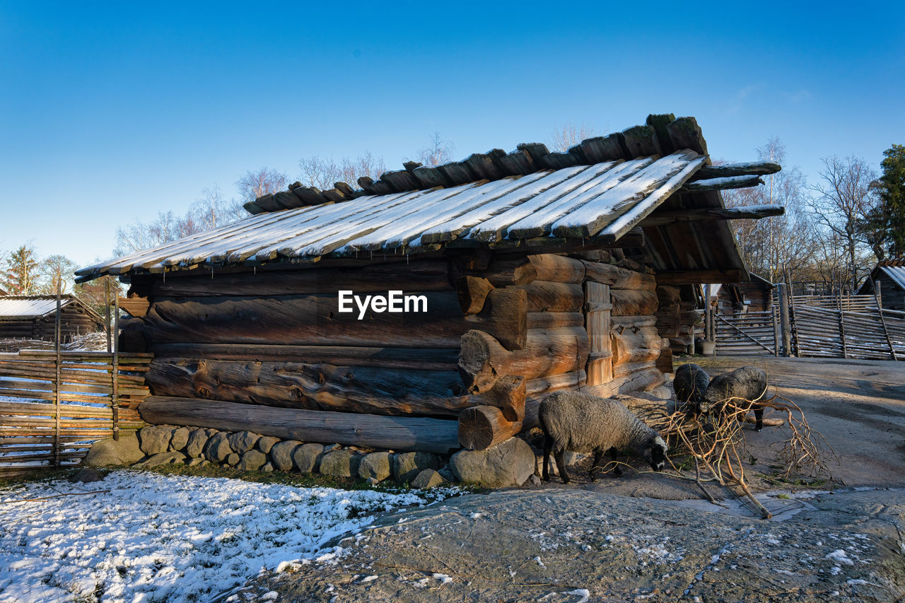 Abandoned building against sky during winter