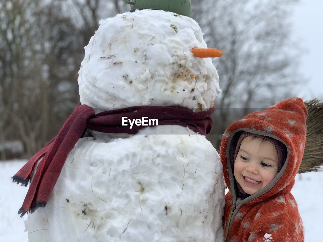 Portrait of happy child with snow man
