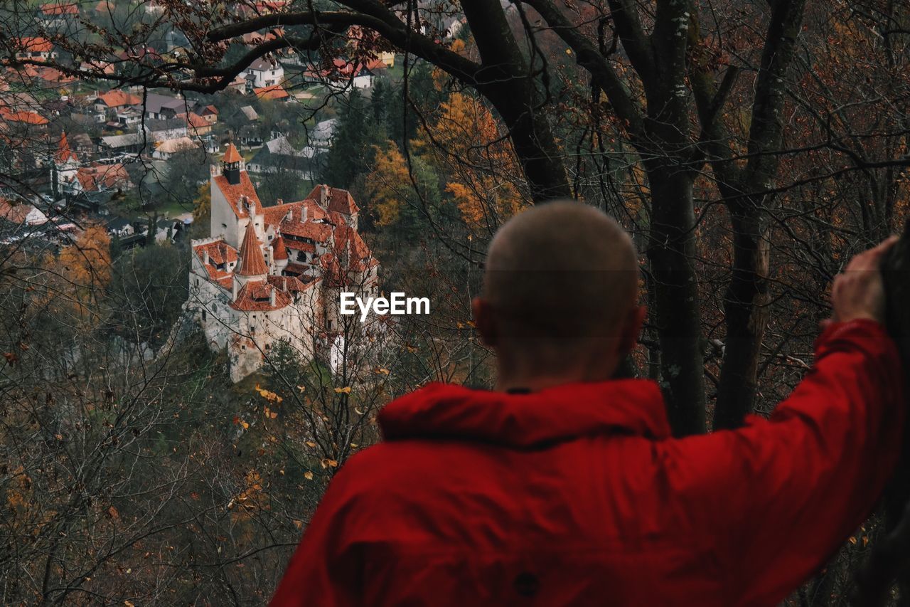 Rear view of man looking at bran castle
