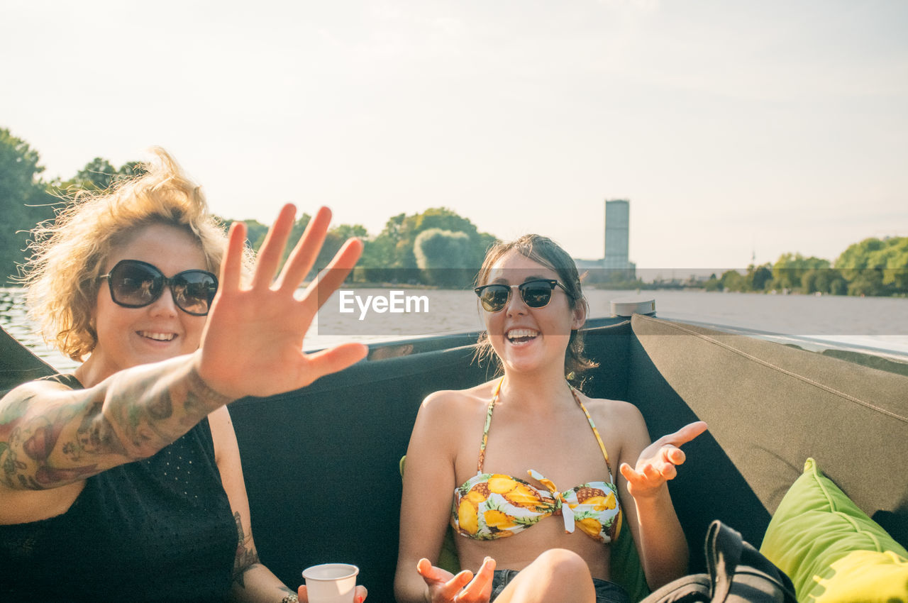 Women sitting and enjoying in boat at river