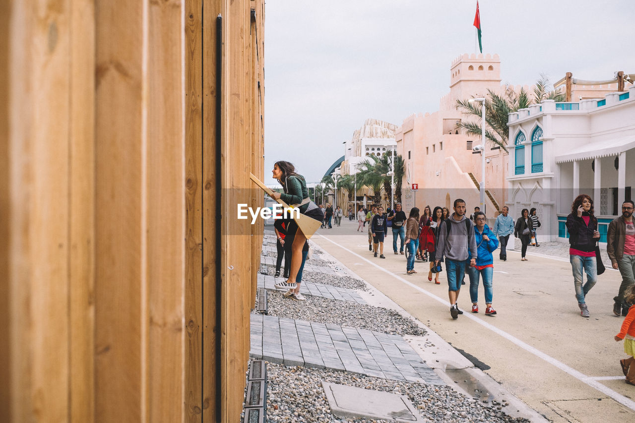 WOMAN STANDING ON CITY STREET