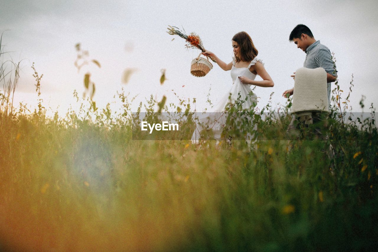 Women on field by plants