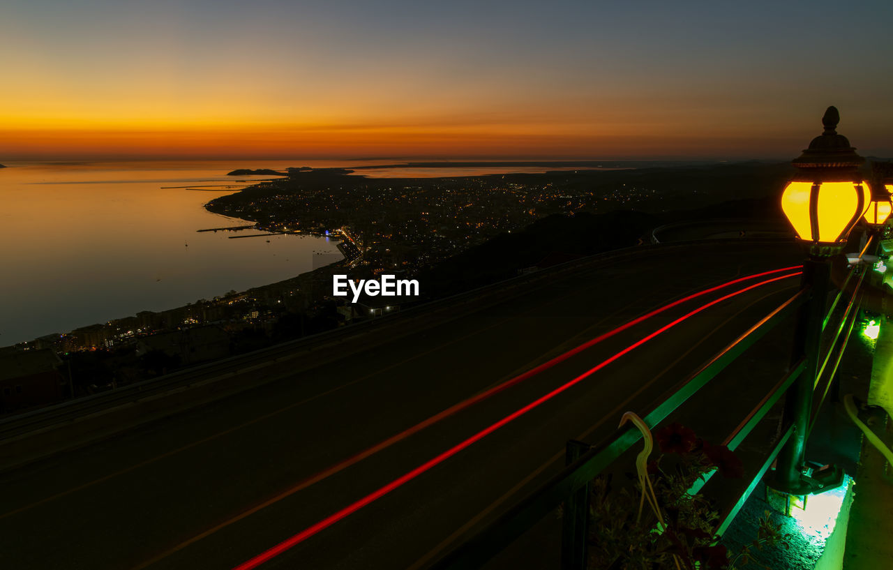 High angle view of light trails on road at sunset