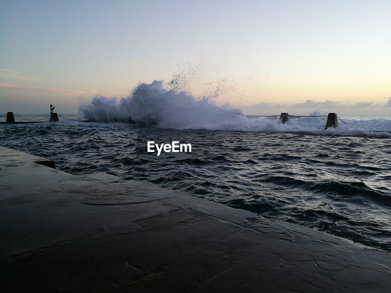 SCENIC VIEW OF BEACH AGAINST SKY DURING SUNSET