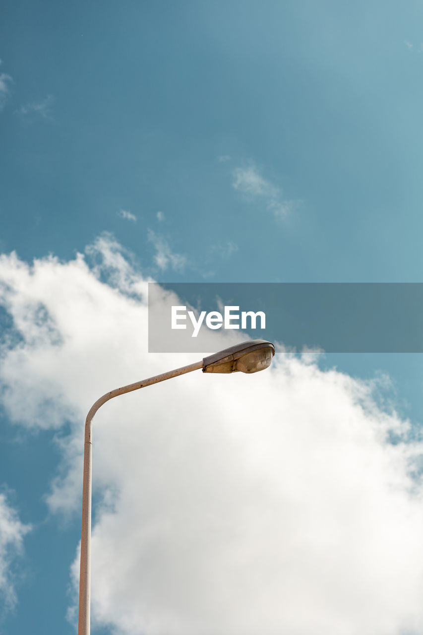 Broken street lamp with a blue sky in the background