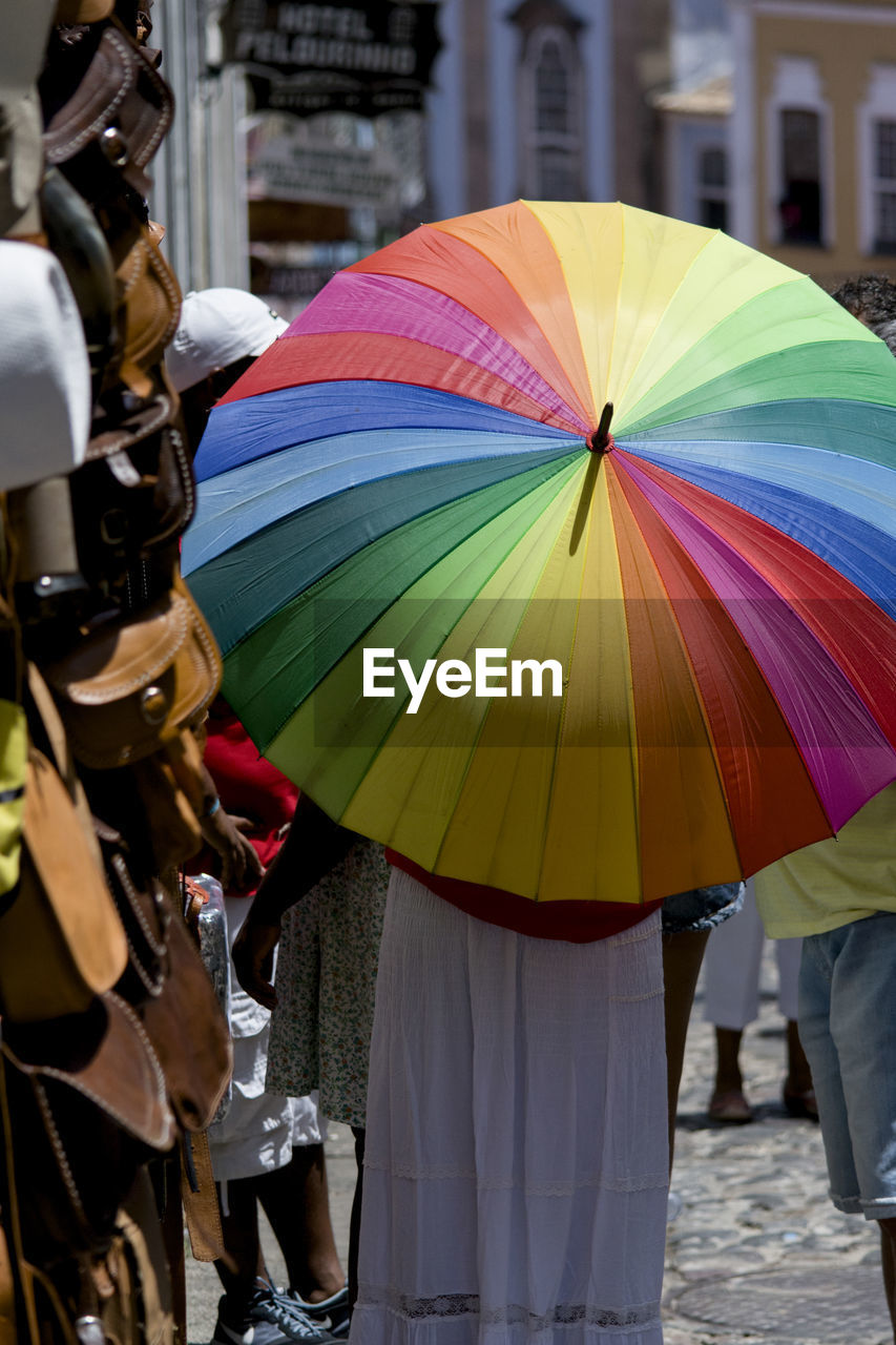 A person walking in the streets of pelourinho with a colorful umbrella. salvador, bahia, brazil