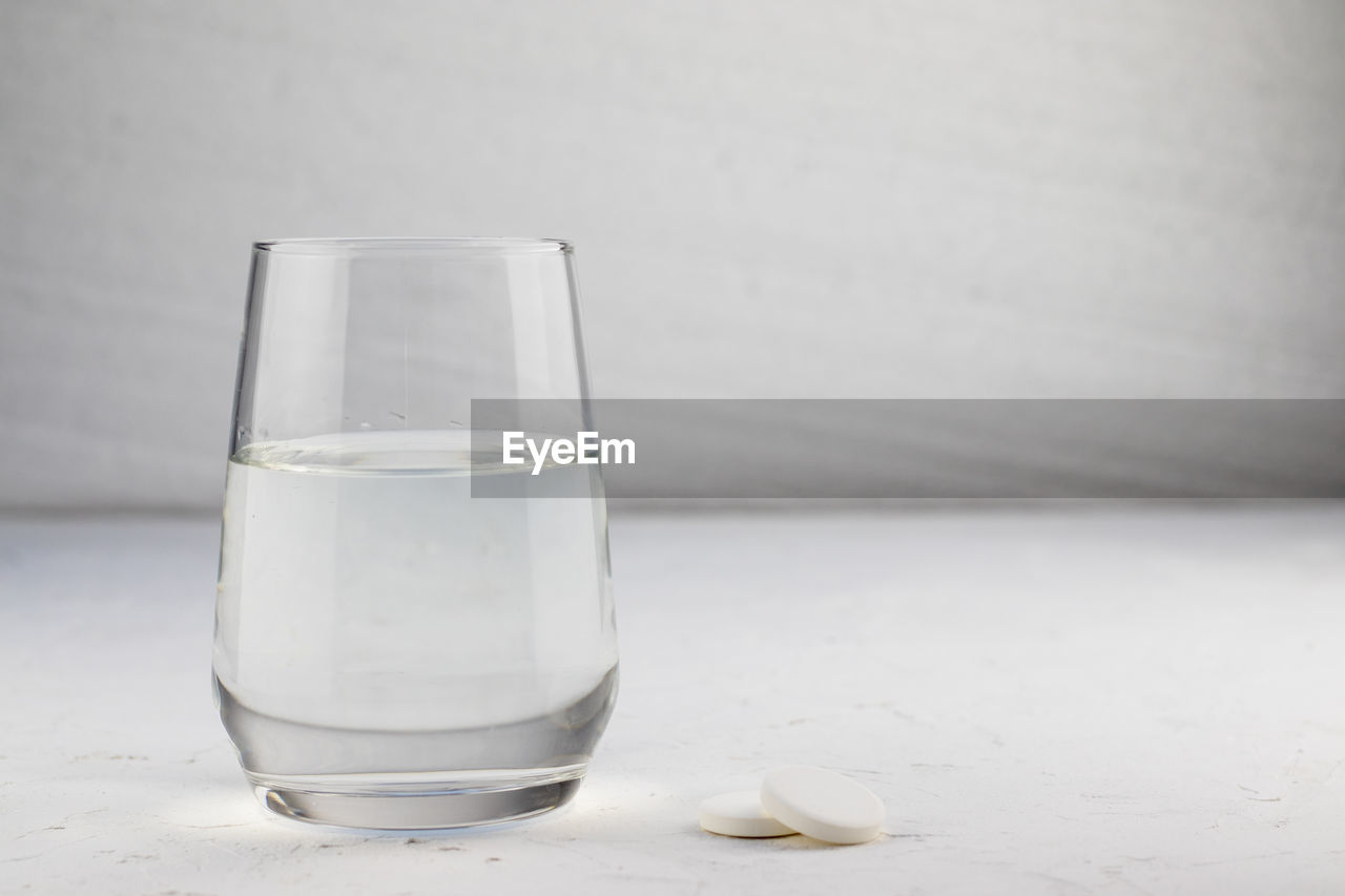 glass, drinking glass, household equipment, white, food and drink, drink, refreshment, water, indoors, studio shot, no people, drinking water, table, lighting, close-up, transparent, freshness, copy space, tableware, still life, old fashioned glass, simplicity, food, nature, highball glass