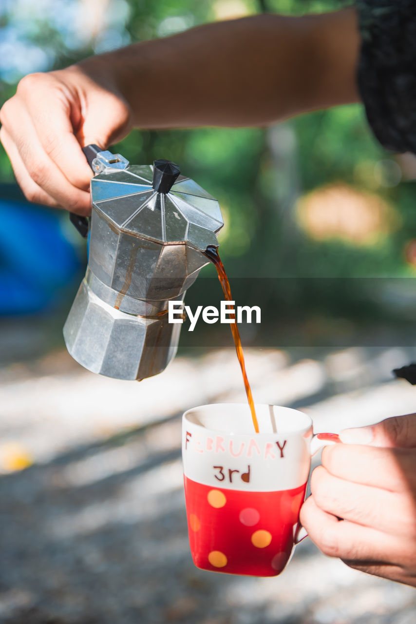 cropped hand of person holding coffee