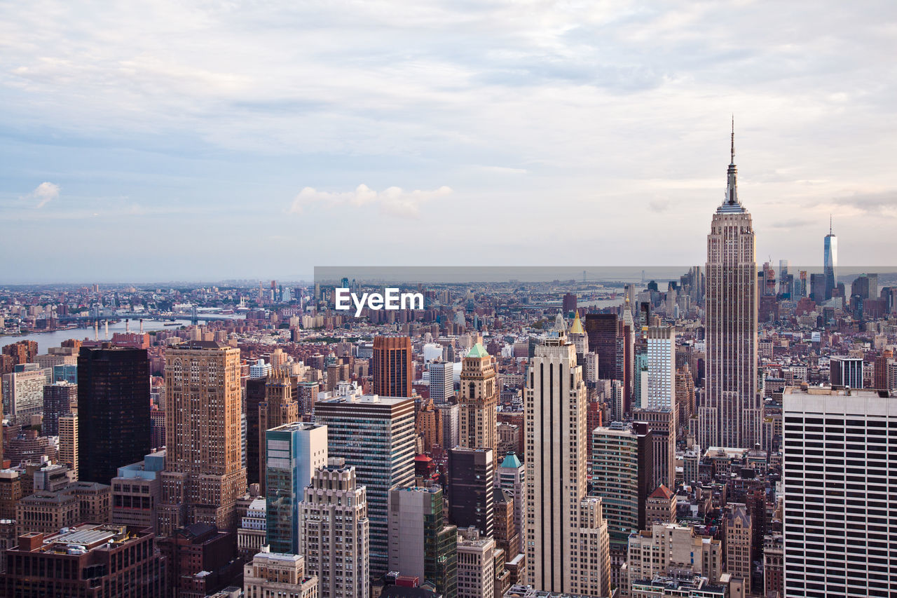 Empire state building with cityscape against sky