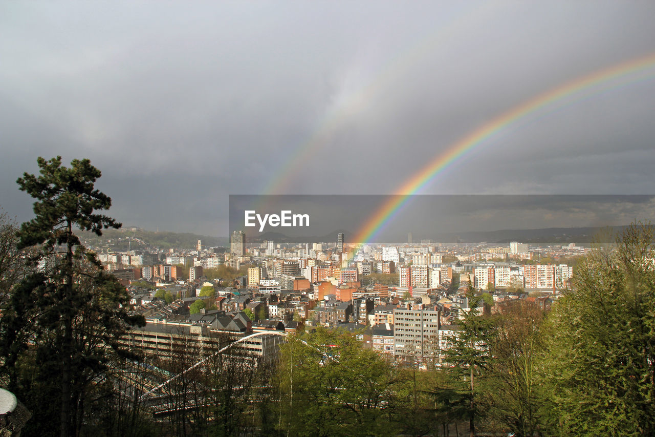 High angle shot of townscape against rainbow