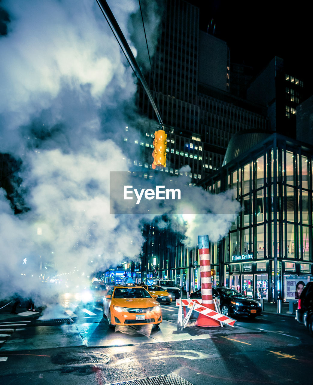 CARS ON ILLUMINATED CITY AGAINST SKY