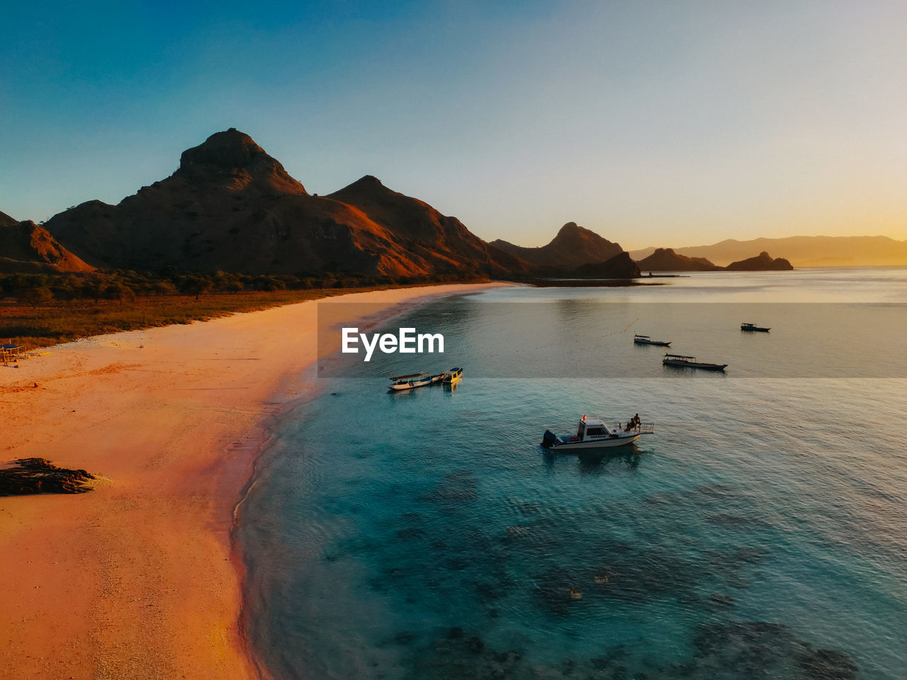 Scenic view of sea and mountains against sky