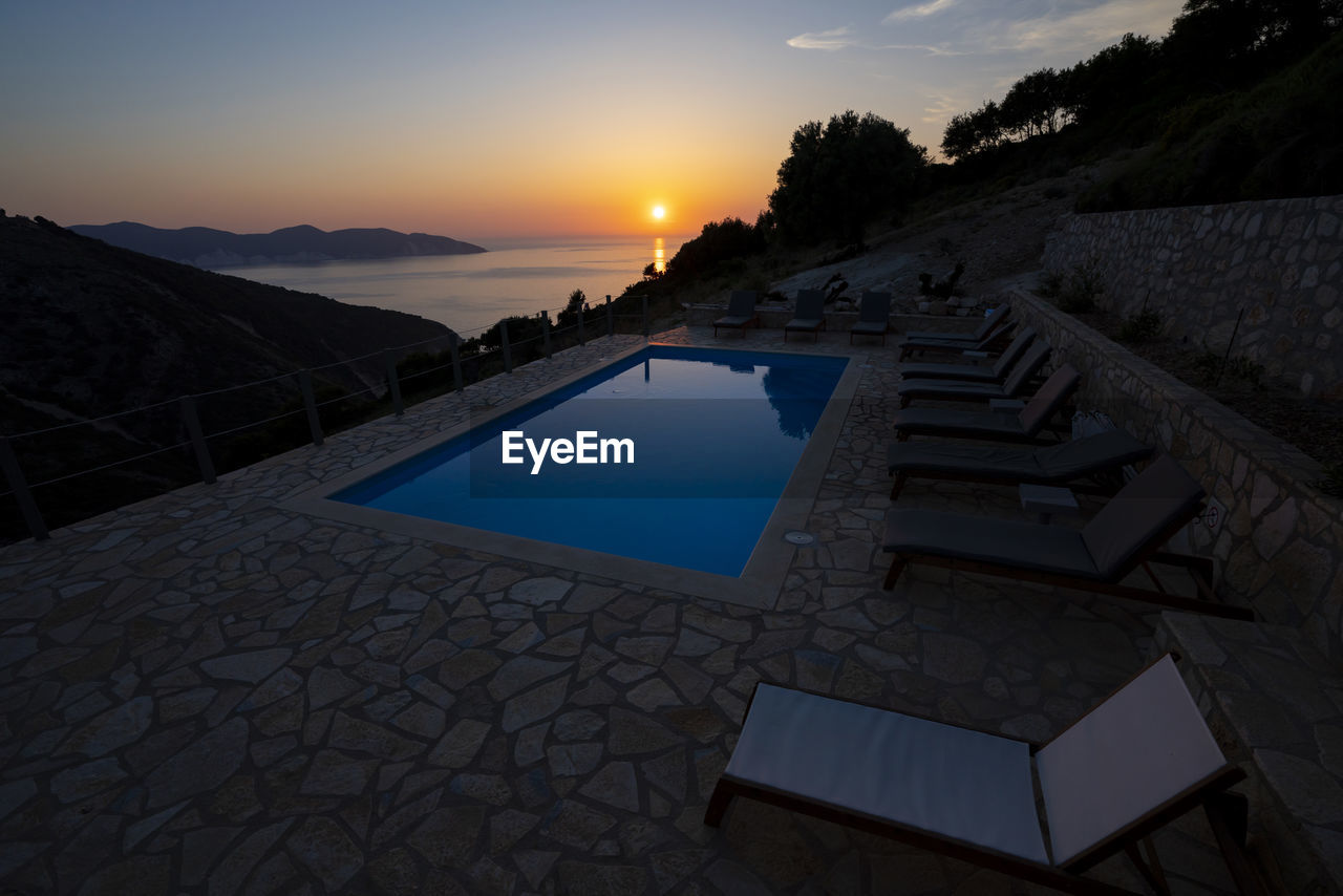 VIEW OF SWIMMING POOL DURING SUNSET